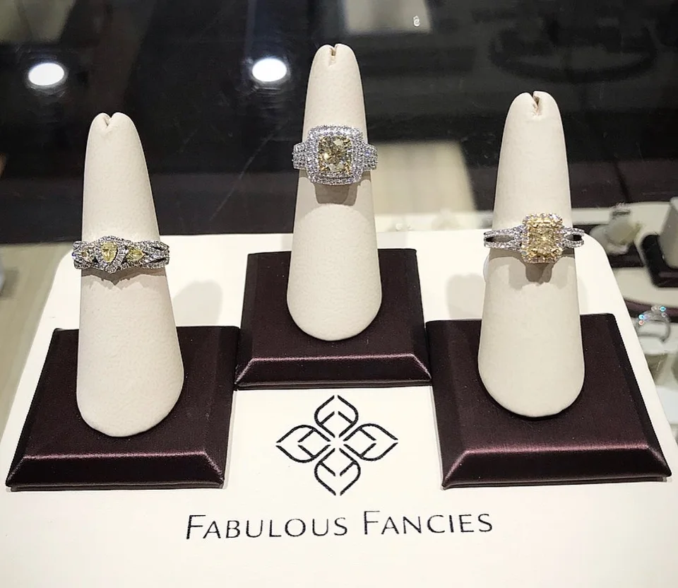 Three yellow diamond rings on display at Mitchell Jewelers