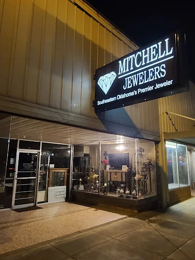 Mitchell Jewelers entrance and illuminated diamond sign in the evening